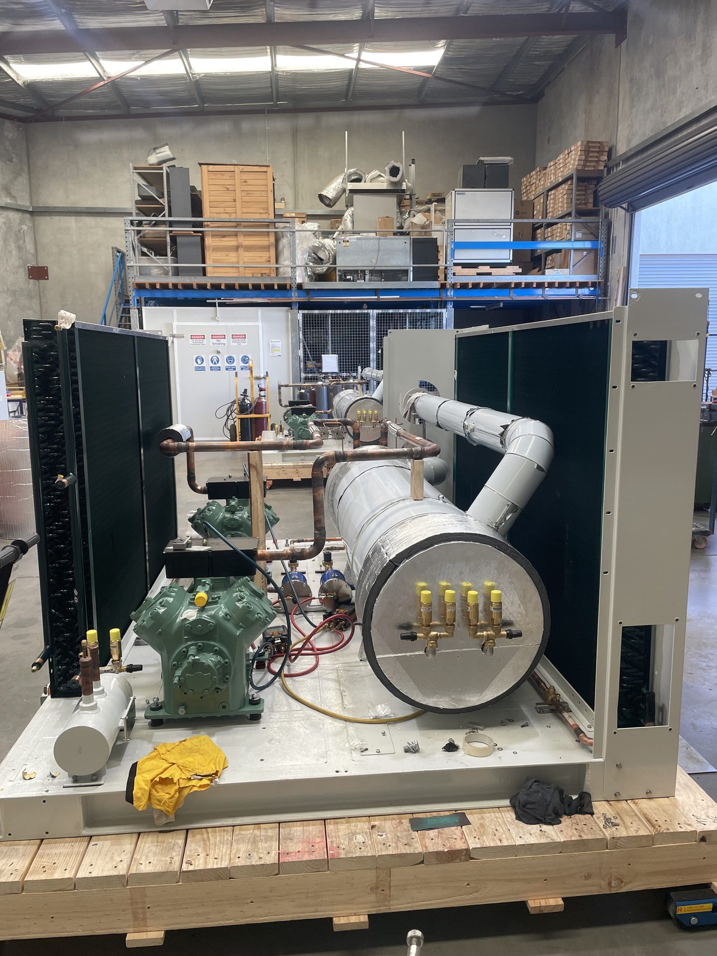 Custom industrial chiller build with twin compressors, copper piping and insulated heat exchangers in the workshop